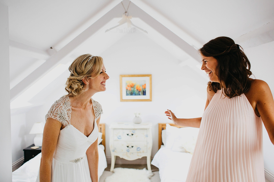 A Suzanne Neville gown and shades fo pink for a colourful wedding at Healey Barn, Northumberland. Photography by John Hope.