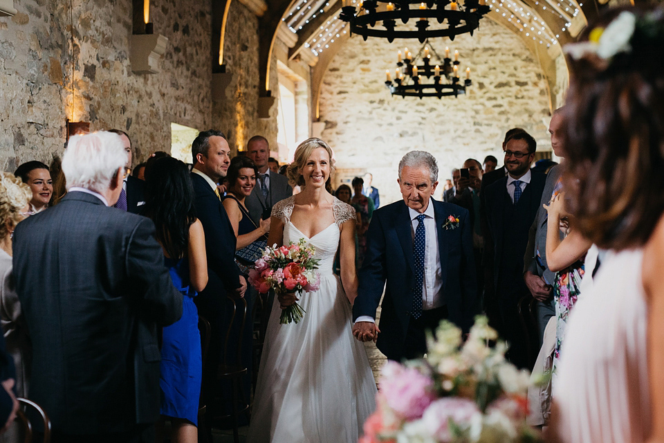 A Suzanne Neville gown and shades fo pink for a colourful wedding at Healey Barn, Northumberland. Photography by John Hope.