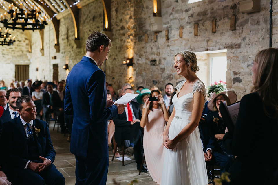 A Suzanne Neville gown and shades fo pink for a colourful wedding at Healey Barn, Northumberland. Photography by John Hope.