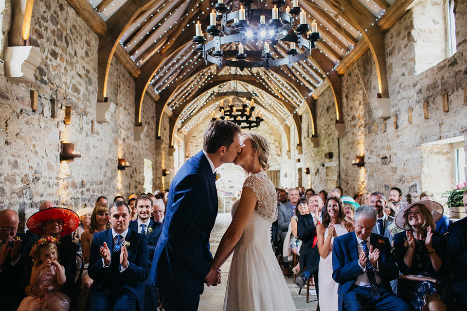 A Suzanne Neville gown and shades fo pink for a colourful wedding at Healey Barn, Northumberland. Photography by John Hope.