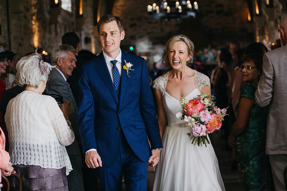 A Suzanne Neville gown and shades fo pink for a colourful wedding at Healey Barn, Northumberland. Photography by John Hope.