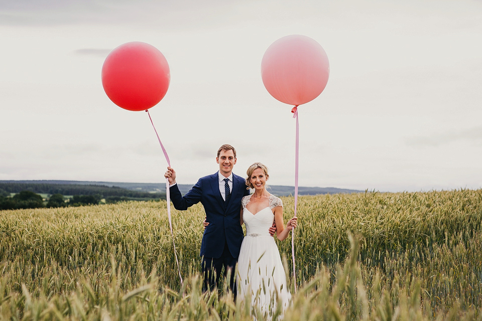 A Suzanne Neville gown and shades fo pink for a colourful wedding at Healey Barn, Northumberland. Photography by John Hope.