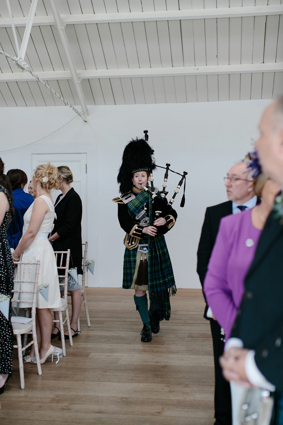 Lauren wears an original vintage 1940s wedding dress and veil for her elegant and colourful wedding at Crear in Scotland. Photography by Caro Weiss.