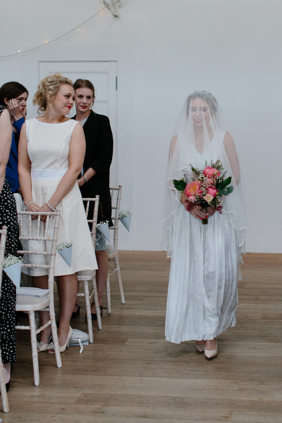 Lauren wears an original vintage 1940s wedding dress and veil for her elegant and colourful wedding at Crear in Scotland. Photography by Caro Weiss.