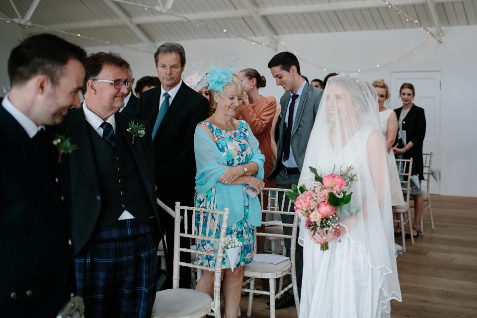 Lauren wears an original vintage 1940s wedding dress and veil for her elegant and colourful wedding at Crear in Scotland. Photography by Caro Weiss.