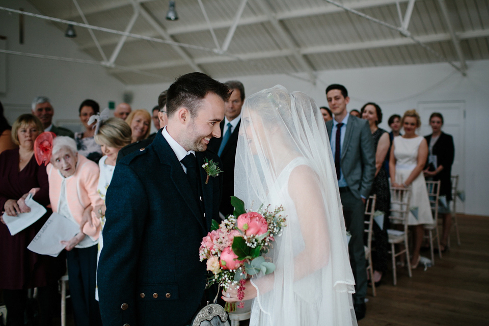 Lauren wears an original vintage 1940s wedding dress and veil for her elegant and colourful wedding at Crear in Scotland. Photography by Caro Weiss.