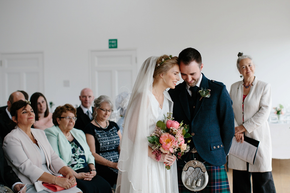 Lauren wears an original vintage 1940s wedding dress and veil for her elegant and colourful wedding at Crear in Scotland. Photography by Caro Weiss.