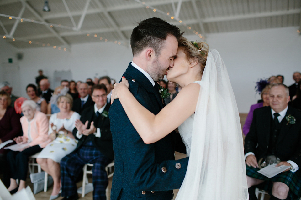 Lauren wears an original vintage 1940s wedding dress and veil for her elegant and colourful wedding at Crear in Scotland. Photography by Caro Weiss.