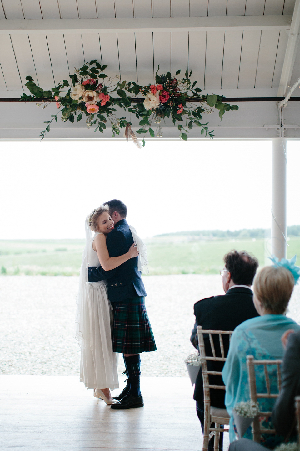 Lauren wears an original vintage 1940s wedding dress and veil for her elegant and colourful wedding at Crear in Scotland. Photography by Caro Weiss.