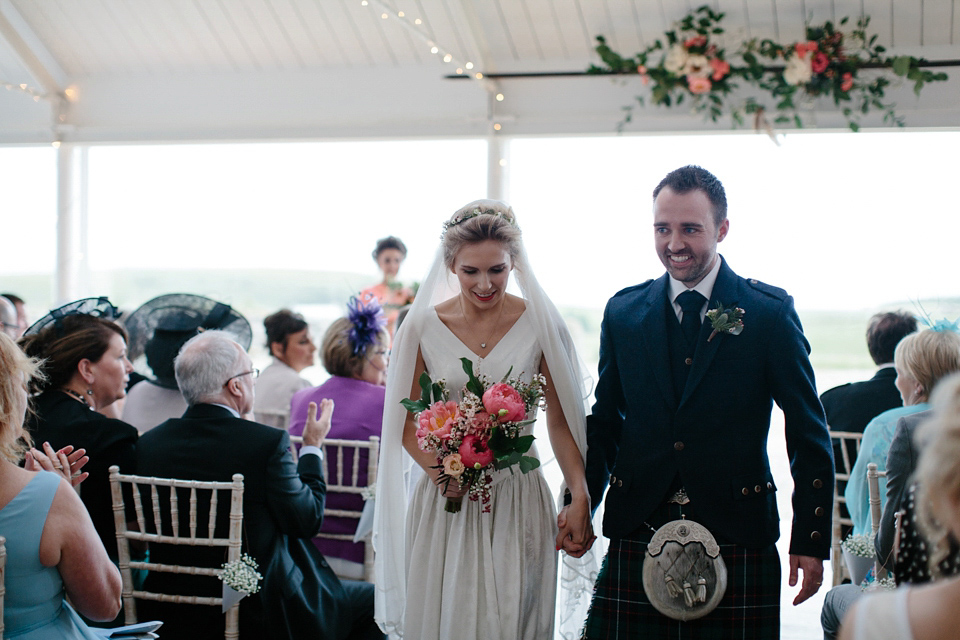 Lauren wears an original vintage 1940s wedding dress and veil for her elegant and colourful wedding at Crear in Scotland. Photography by Caro Weiss.