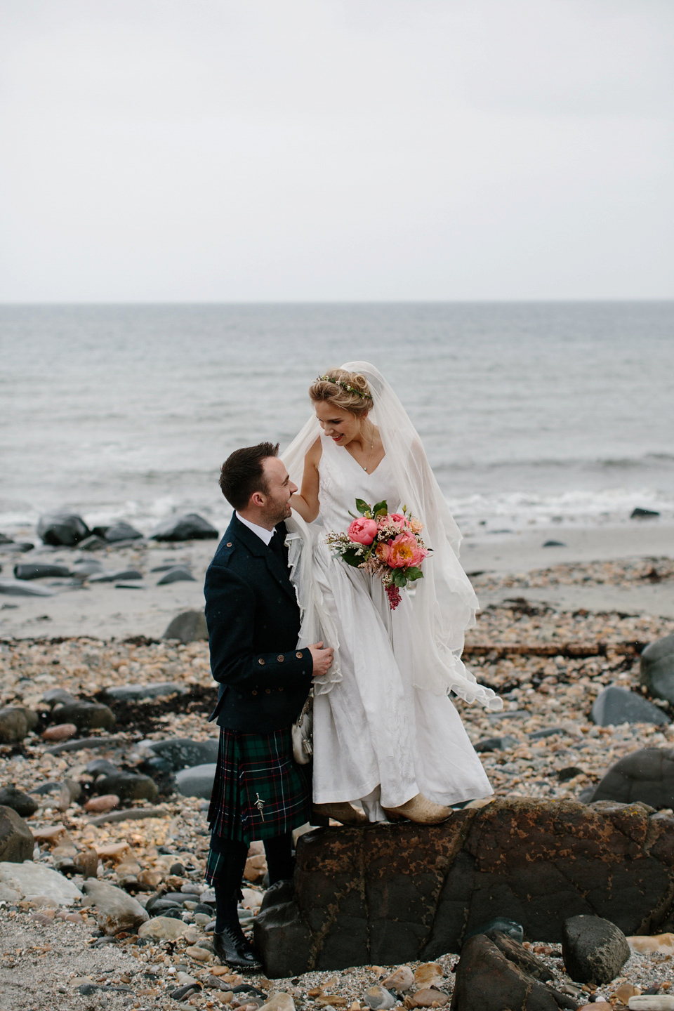 Lauren wears an original vintage 1940s wedding dress and veil for her elegant and colourful wedding at Crear in Scotland. Photography by Caro Weiss.