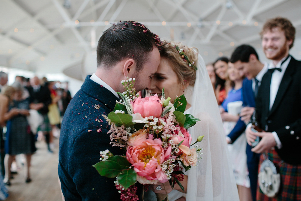 Lauren wears an original vintage 1940s wedding dress and veil for her elegant and colourful wedding at Crear in Scotland. Photography by Caro Weiss.