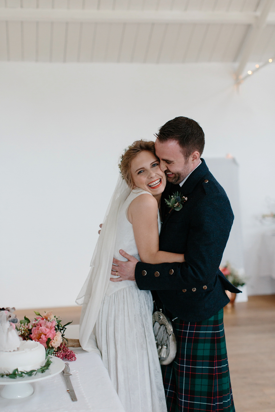 Lauren wears an original vintage 1940s wedding dress and veil for her elegant and colourful wedding at Crear in Scotland. Photography by Caro Weiss.