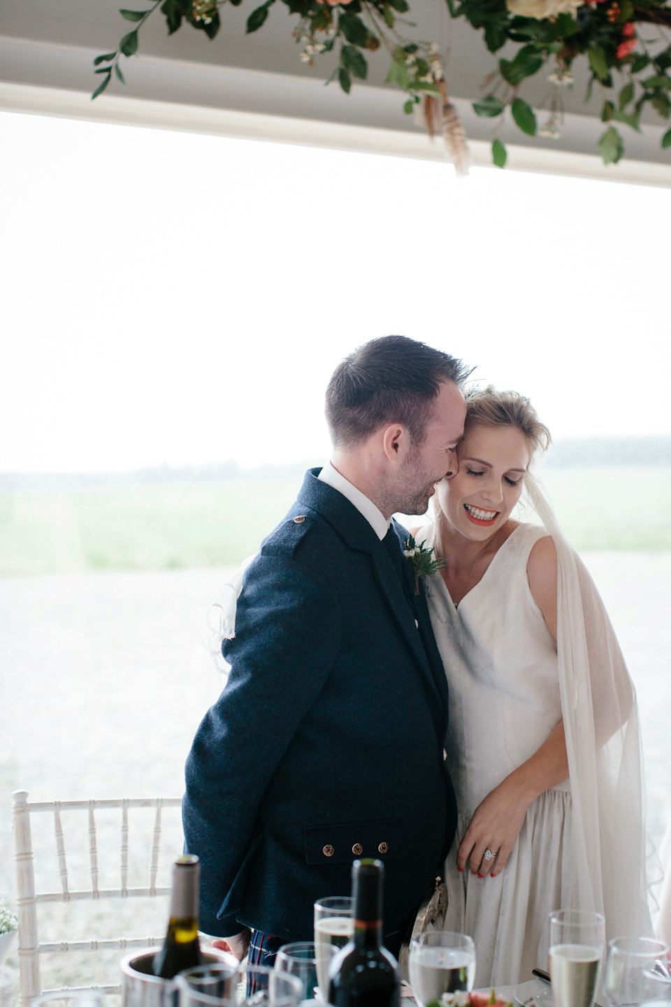 Lauren wears an original vintage 1940s wedding dress and veil for her elegant and colourful wedding at Crear in Scotland. Photography by Caro Weiss.