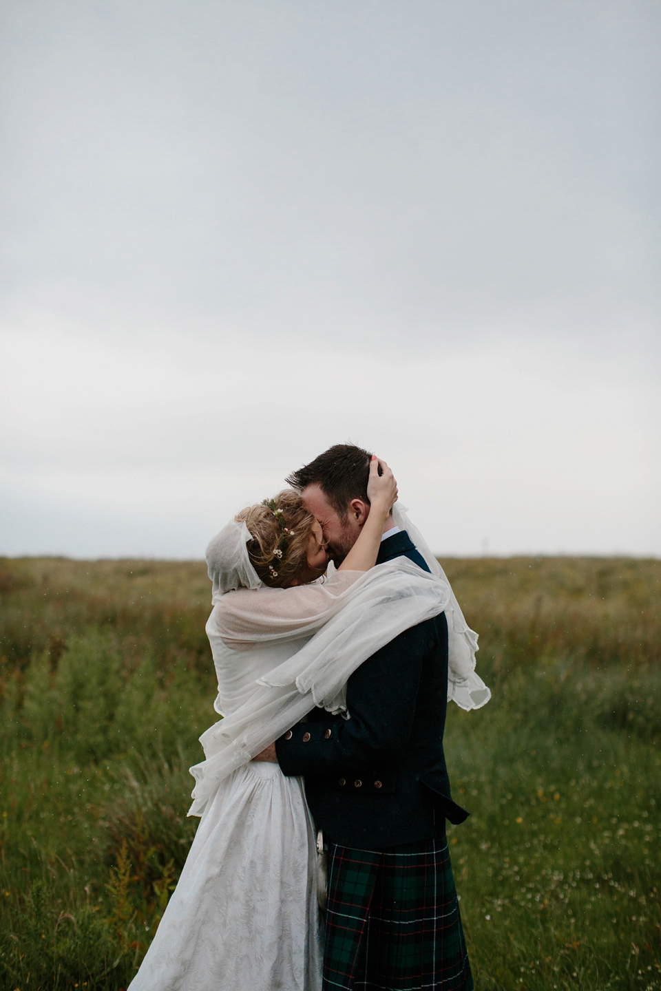 Lauren wears an original vintage 1940s wedding dress and veil for her elegant and colourful wedding at Crear in Scotland. Photography by Caro Weiss.