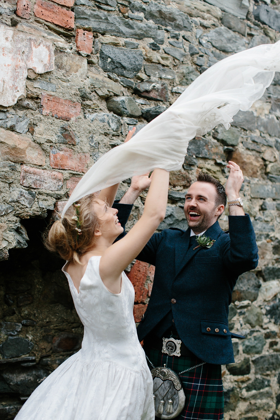 Lauren wears an original vintage 1940s wedding dress and veil for her elegant and colourful wedding at Crear in Scotland. Photography by Caro Weiss.