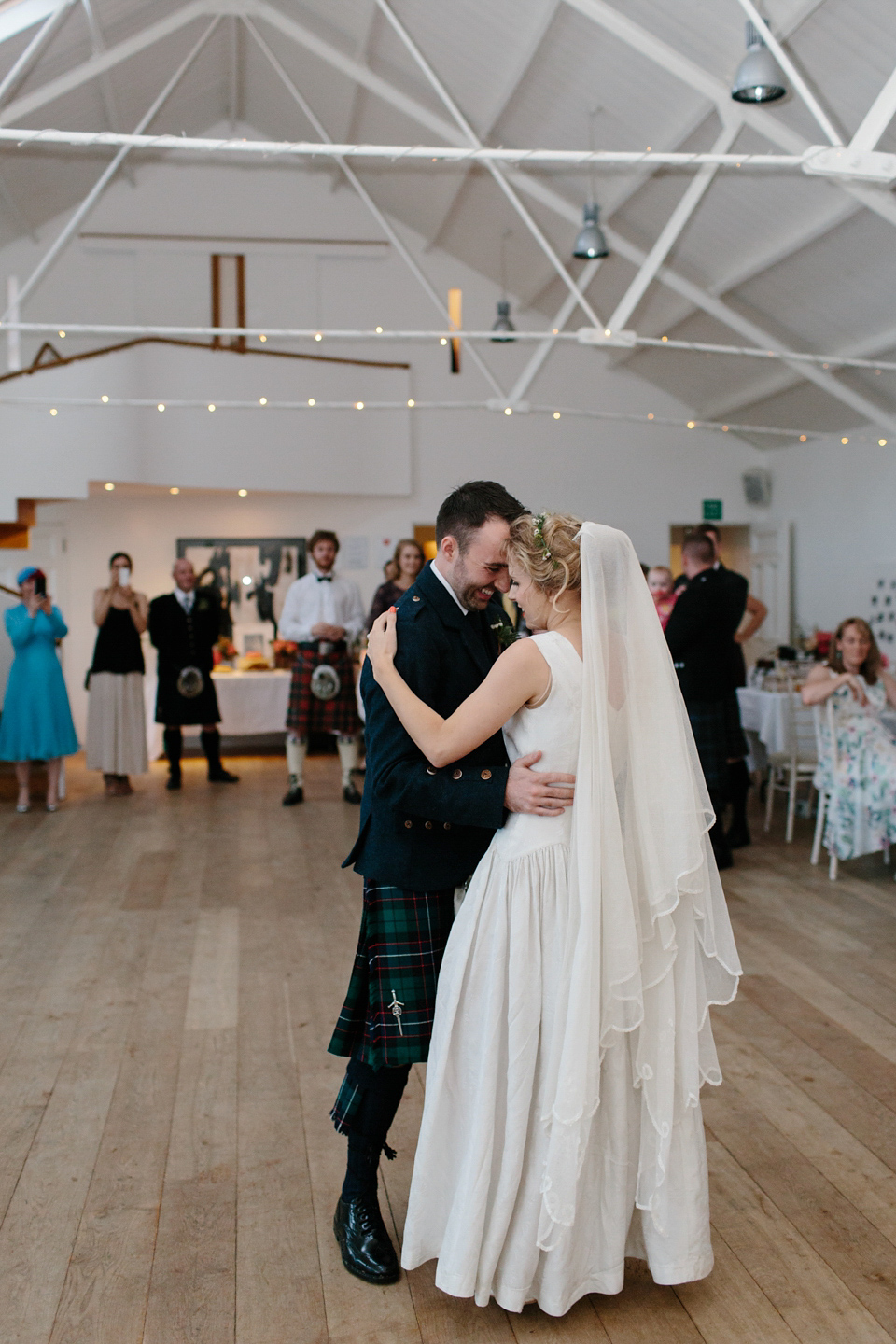 Lauren wears an original vintage 1940s wedding dress and veil for her elegant and colourful wedding at Crear in Scotland. Photography by Caro Weiss.