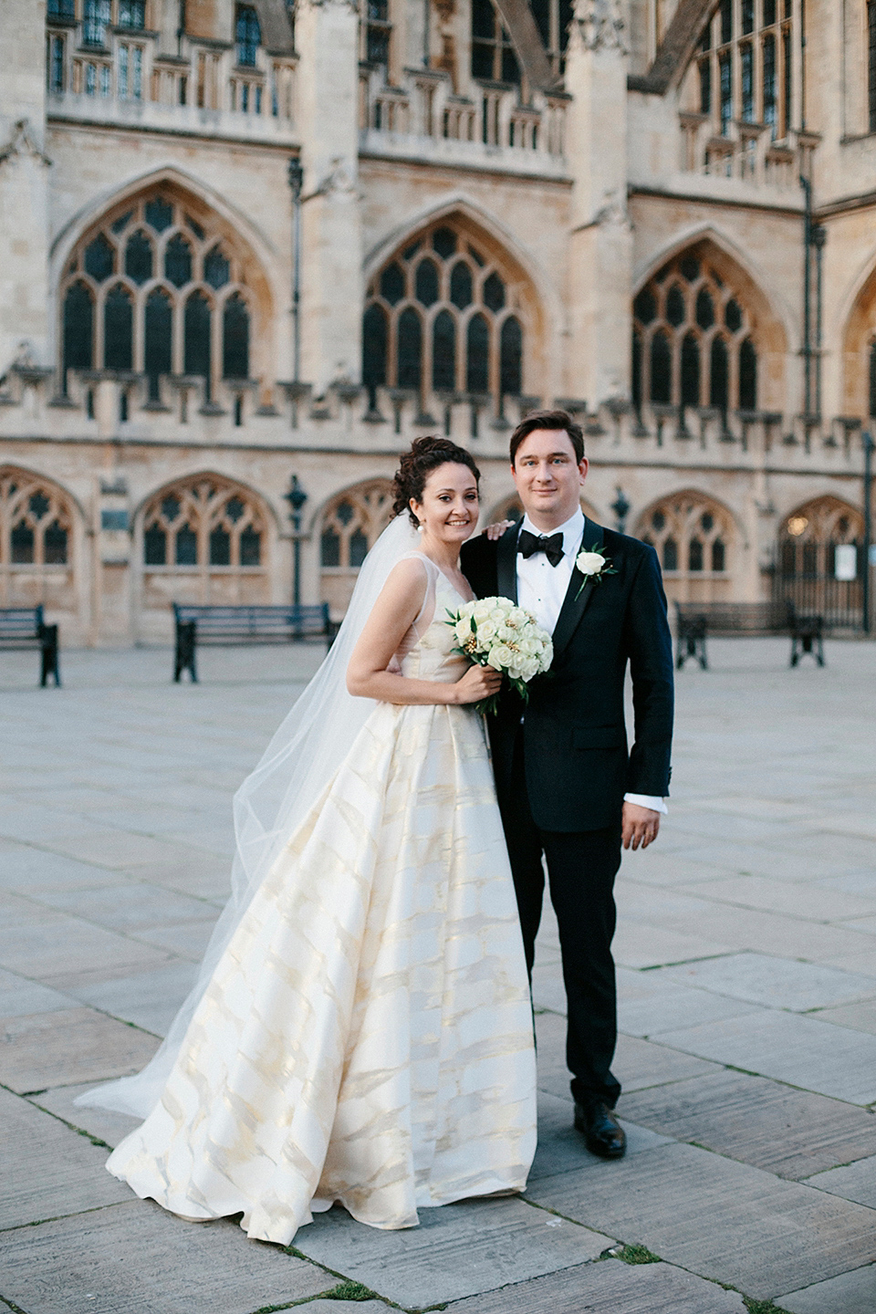 Bride Jennifer wears a gold Lela Rose wedding dress for her Roman Baths wedding. Her maids wear Rachel Gilbert. Images by A Thing Like That Photography.