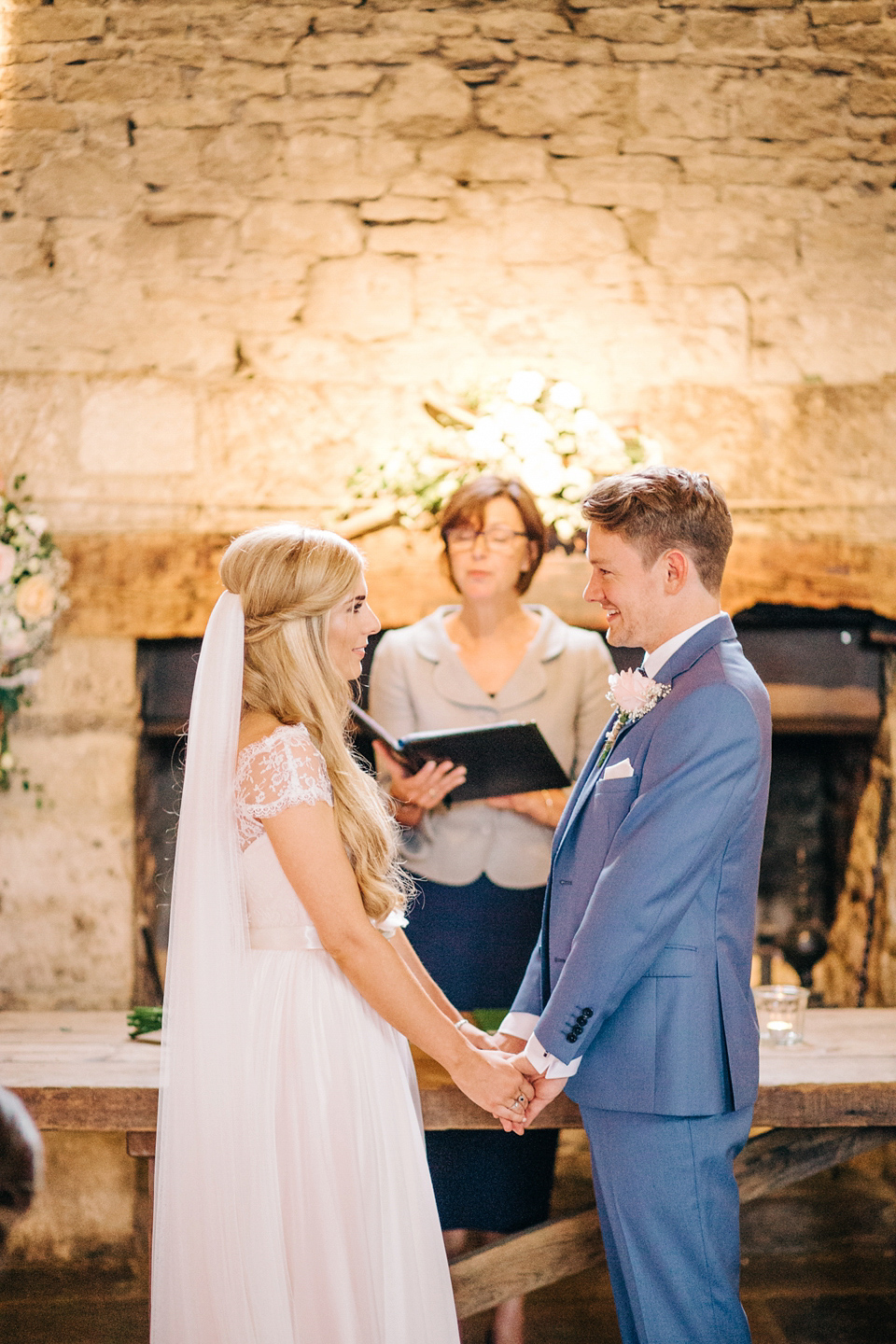 Bride Melanie wears the 'fleur' gown by Naomi Neoh for her Cripps Barn wedding. Her bridesmaids are most pretty in soft pink by 'For Her & For Him'. Images by M&J Photography.