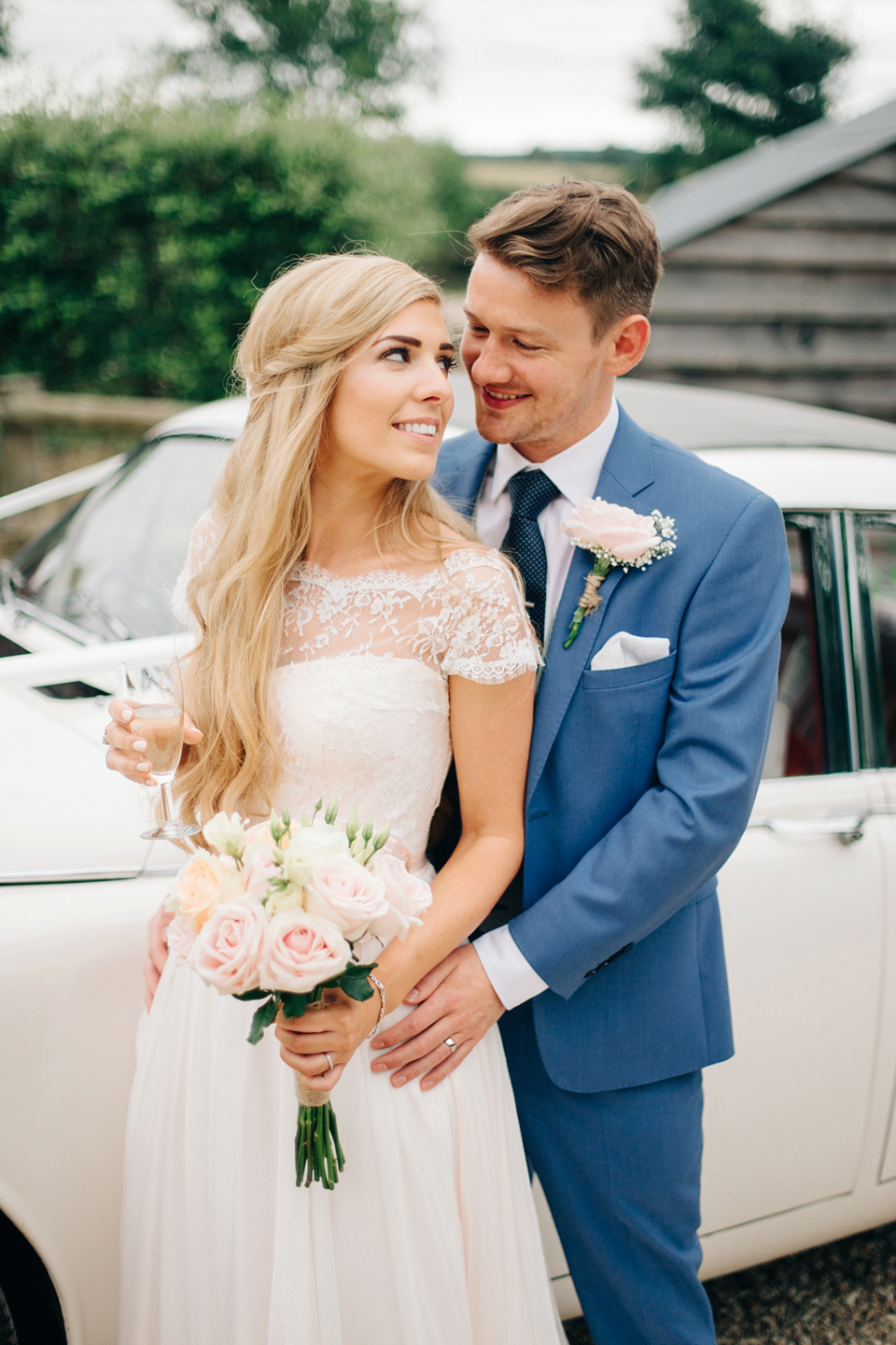 Bride Melanie wears the 'fleur' gown by Naomi Neoh for her Cripps Barn wedding. Her bridesmaids are most pretty in soft pink by 'For Her & For Him'. Images by M&J Photography.