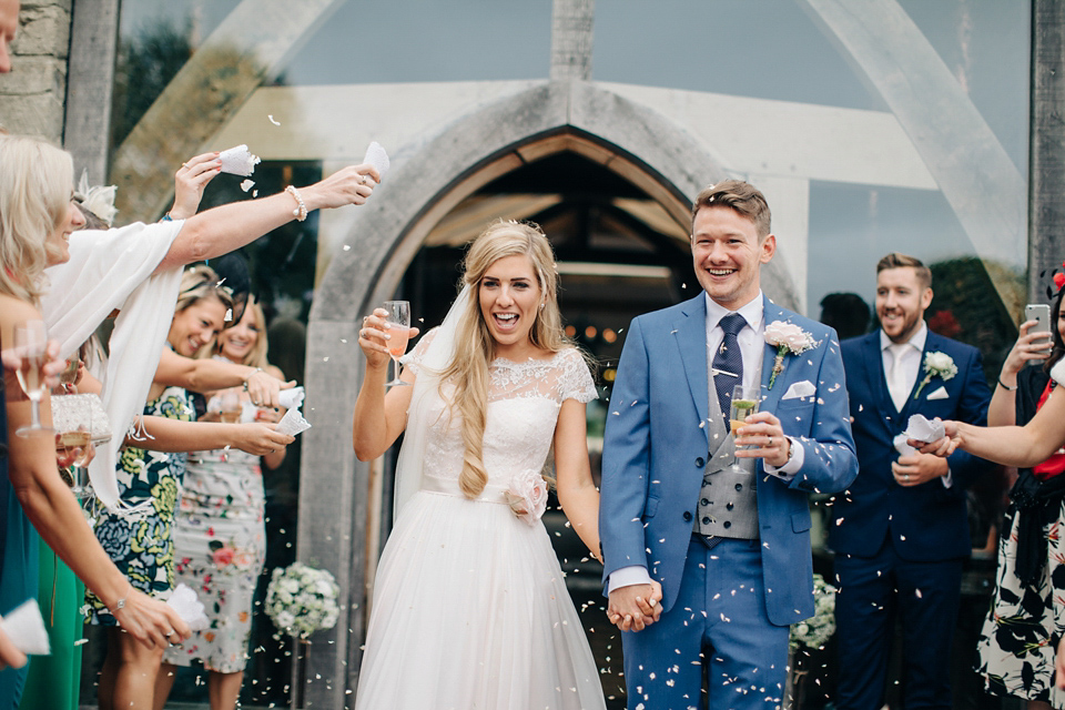 Bride Melanie wears the 'fleur' gown by Naomi Neoh for her Cripps Barn wedding. Her bridesmaids are most pretty in soft pink by 'For Her & For Him'. Images by M&J Photography.