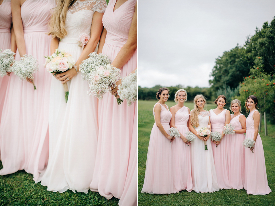 Bride Melanie wears the 'fleur' gown by Naomi Neoh for her Cripps Barn wedding. Her bridesmaids are most pretty in soft pink by 'For Her & For Him'. Images by M&J Photography.