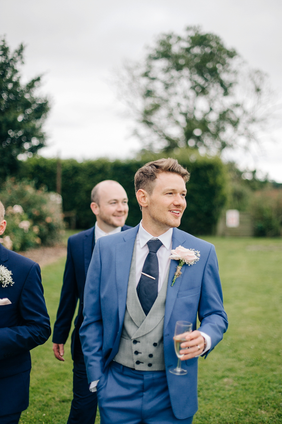 Bride Melanie wears the 'fleur' gown by Naomi Neoh for her Cripps Barn wedding. Her bridesmaids are most pretty in soft pink by 'For Her & For Him'. Images by M&J Photography.