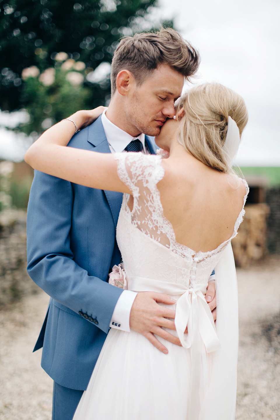 Bride Melanie wears the 'fleur' gown by Naomi Neoh for her Cripps Barn wedding. Her bridesmaids are most pretty in soft pink by 'For Her & For Him'. Images by M&J Photography.