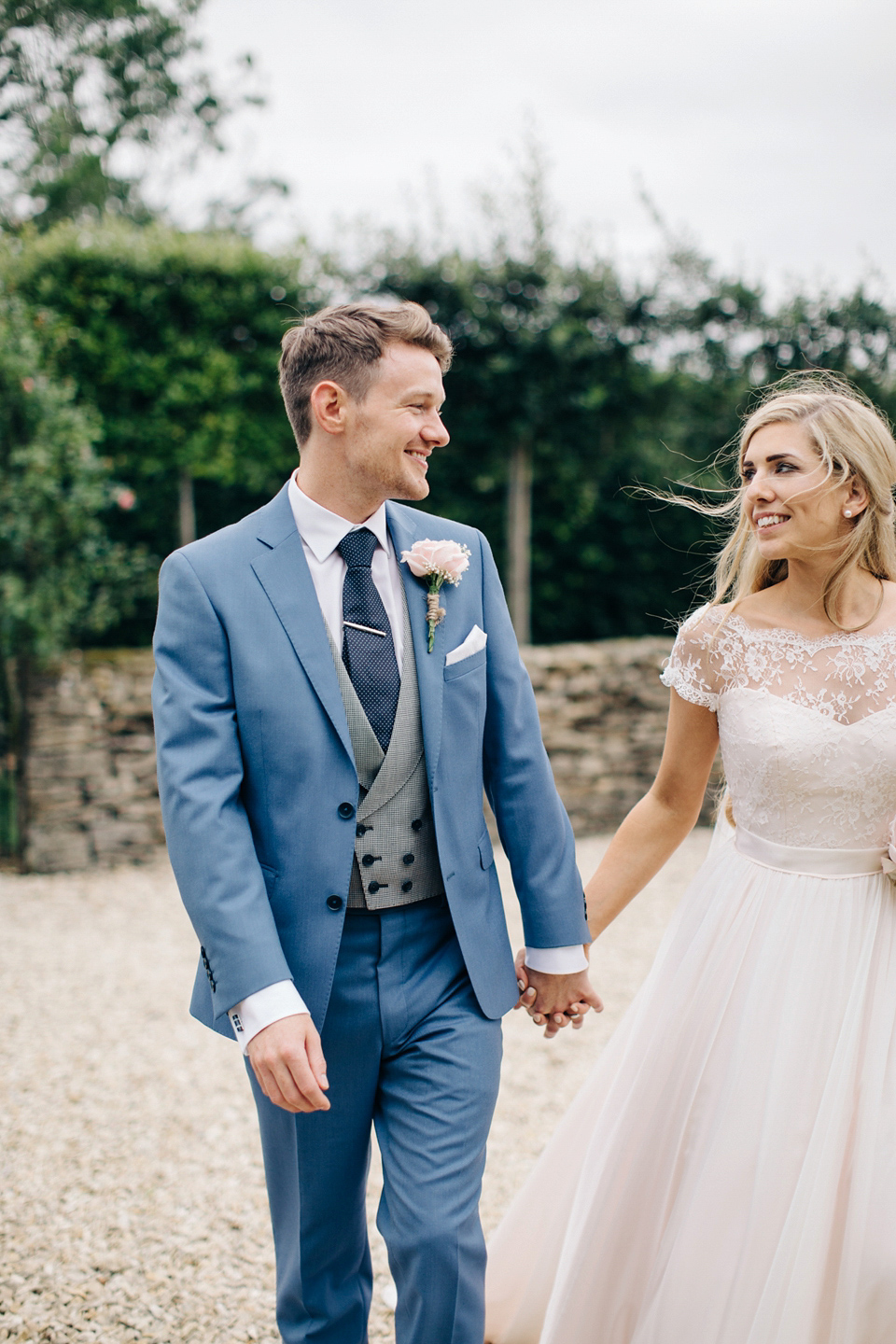 Bride Melanie wears the 'fleur' gown by Naomi Neoh for her Cripps Barn wedding. Her bridesmaids are most pretty in soft pink by 'For Her & For Him'. Images by M&J Photography.