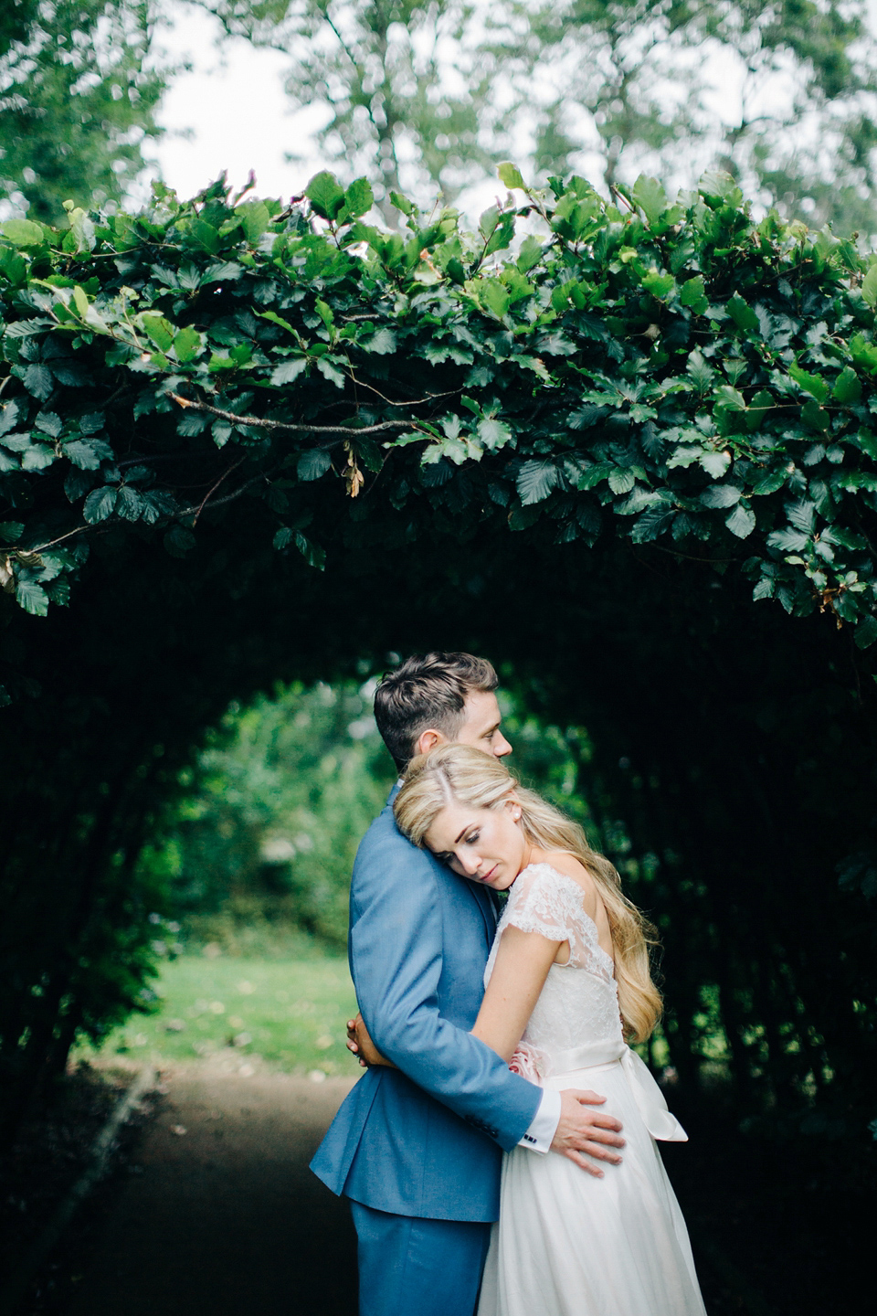 Bride Melanie wears the 'fleur' gown by Naomi Neoh for her Cripps Barn wedding. Her bridesmaids are most pretty in soft pink by 'For Her & For Him'. Images by M&J Photography.