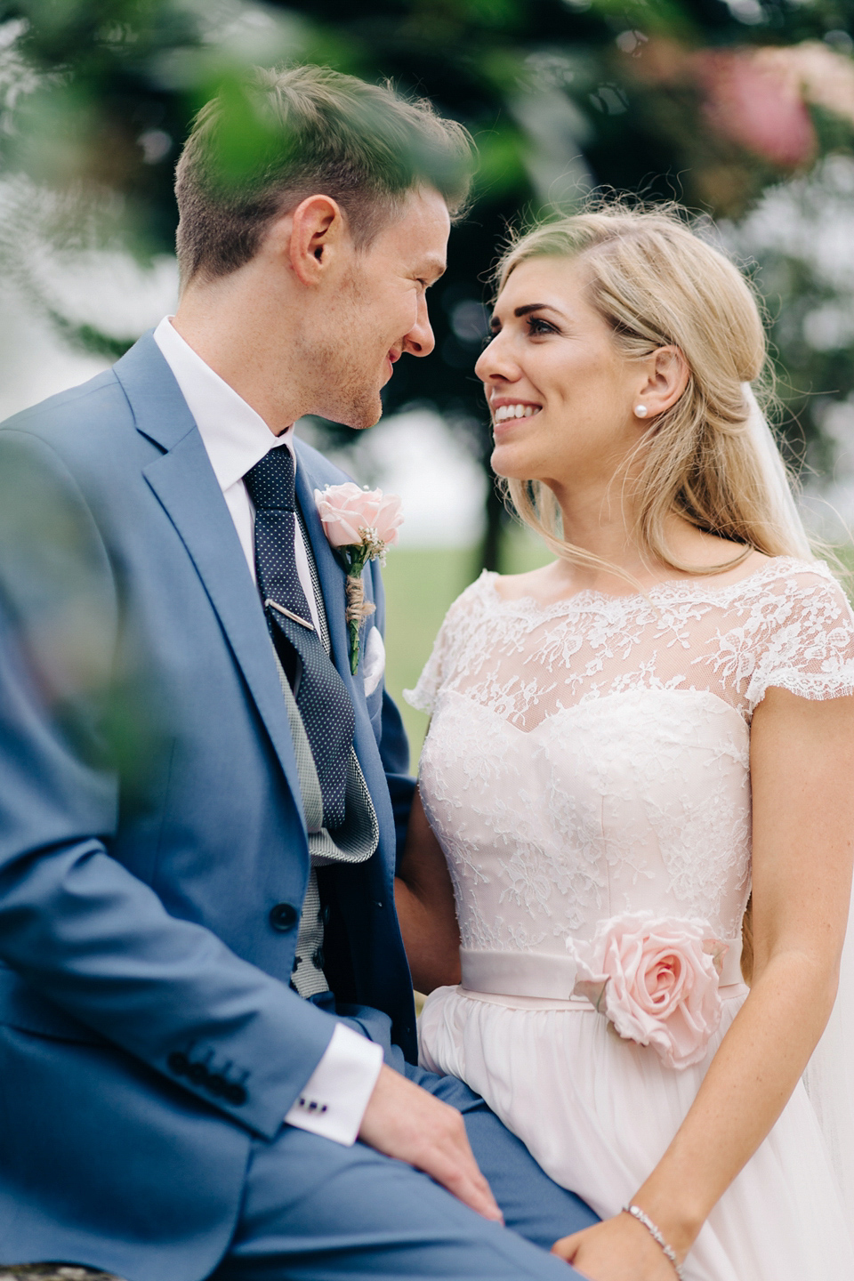 Bride Melanie wears the 'fleur' gown by Naomi Neoh for her Cripps Barn wedding. Her bridesmaids are most pretty in soft pink by 'For Her & For Him'. Images by M&J Photography.