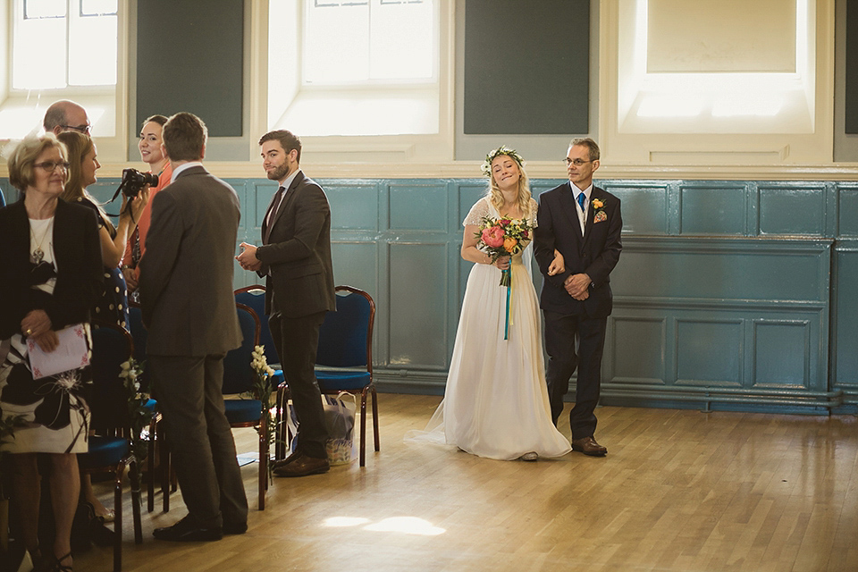 Bride Kate wears a Grace Loves Lace gown for her colourful and Fiesta inspired village hall wedding. Photography by Tom Ravenshear.