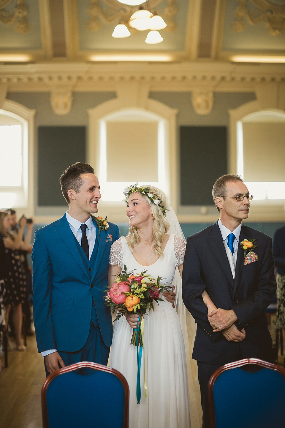 Bride Kate wears a Grace Loves Lace gown for her colourful and Fiesta inspired village hall wedding. Photography by Tom Ravenshear.