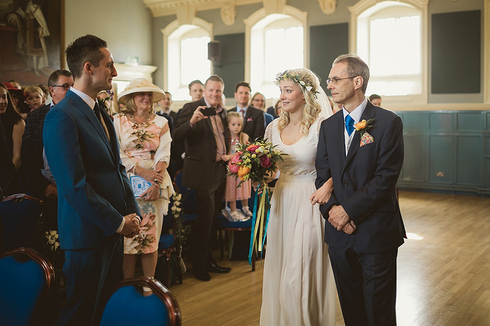 Bride Kate wears a Grace Loves Lace gown for her colourful and Fiesta inspired village hall wedding. Photography by Tom Ravenshear.