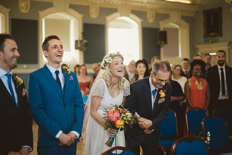 Bride Kate wears a Grace Loves Lace gown for her colourful and Fiesta inspired village hall wedding. Photography by Tom Ravenshear.