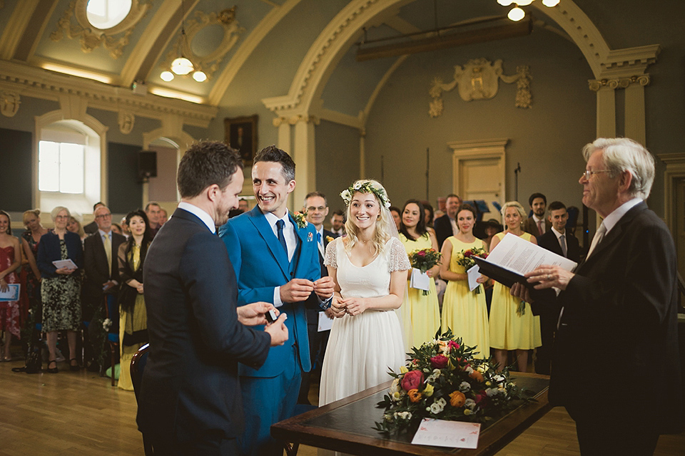 Bride Kate wears a Grace Loves Lace gown for her colourful and Fiesta inspired village hall wedding. Photography by Tom Ravenshear.