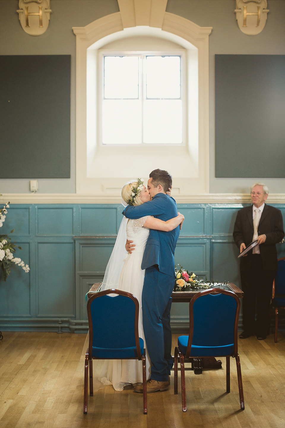 Bride Kate wears a Grace Loves Lace gown for her colourful and Fiesta inspired village hall wedding. Photography by Tom Ravenshear.