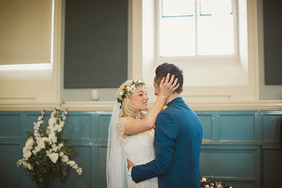 Bride Kate wears a Grace Loves Lace gown for her colourful and Fiesta inspired village hall wedding. Photography by Tom Ravenshear.