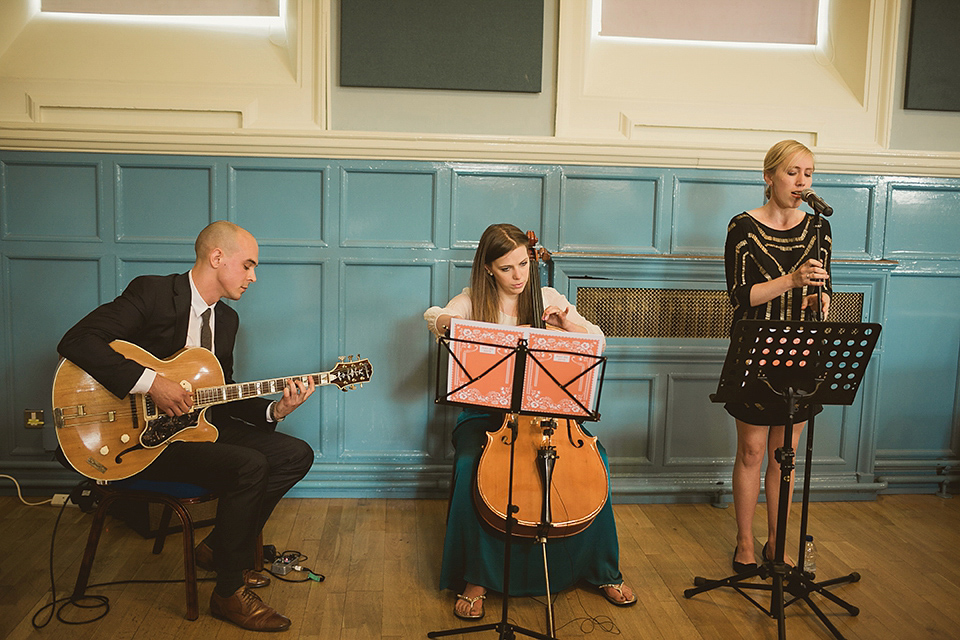 Bride Kate wears a Grace Loves Lace gown for her colourful and Fiesta inspired village hall wedding. Photography by Tom Ravenshear.