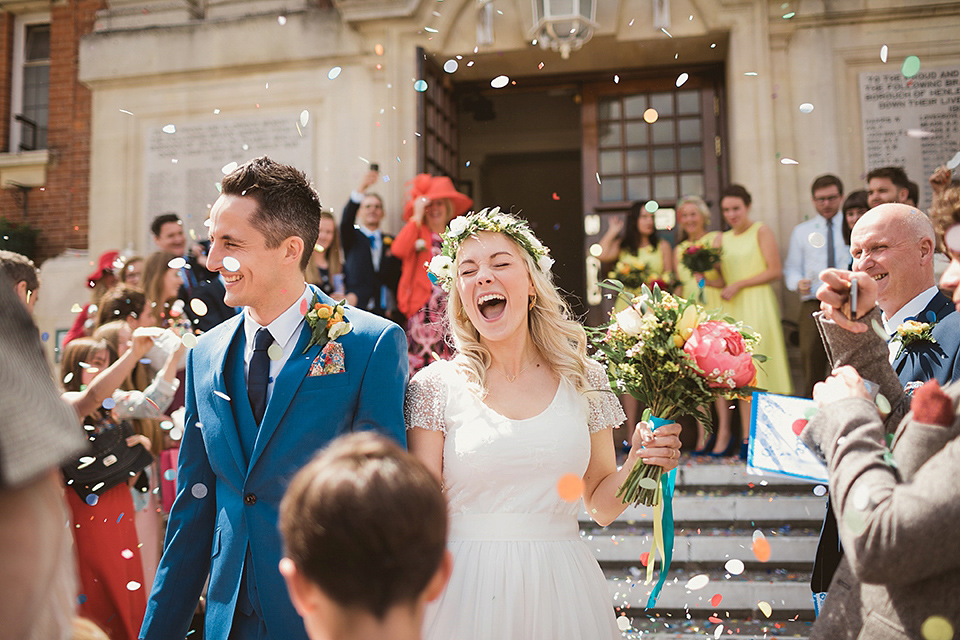 Bride Kate wears a Grace Loves Lace gown for her colourful and Fiesta inspired village hall wedding. Photography by Tom Ravenshear.