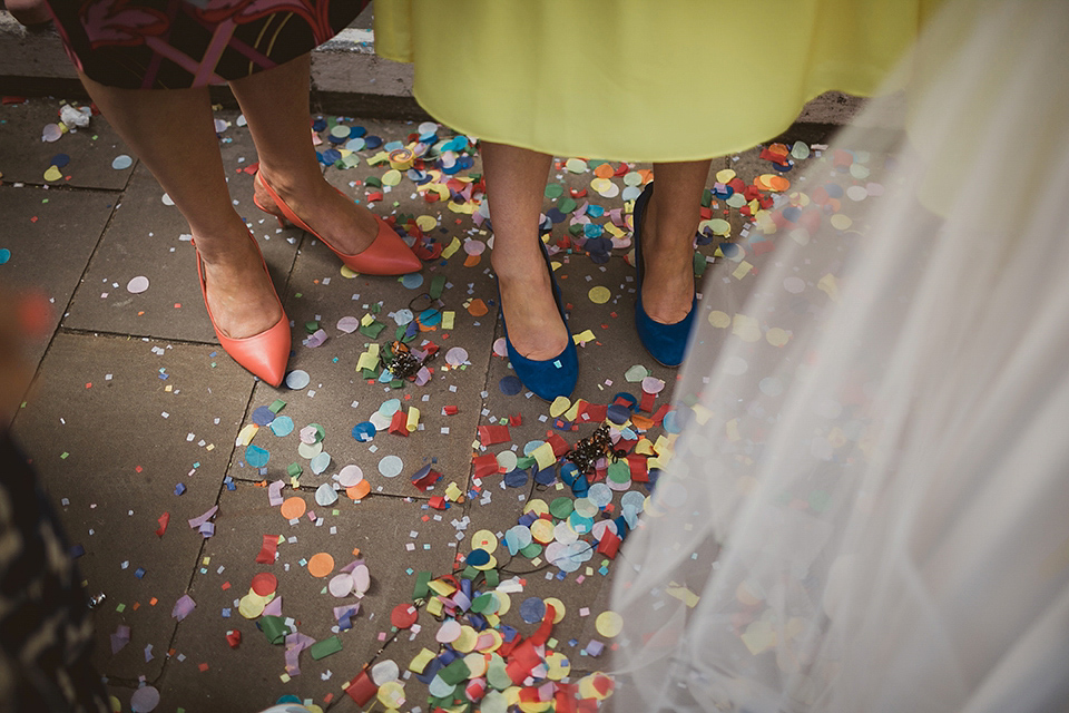 Bride Kate wears a Grace Loves Lace gown for her colourful and Fiesta inspired village hall wedding. Photography by Tom Ravenshear.