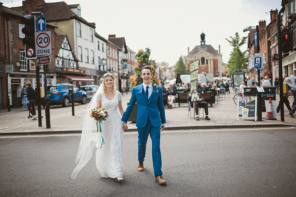 Bride Kate wears a Grace Loves Lace gown for her colourful and Fiesta inspired village hall wedding. Photography by Tom Ravenshear.