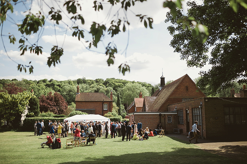 Bride Kate wears a Grace Loves Lace gown for her colourful and Fiesta inspired village hall wedding. Photography by Tom Ravenshear.