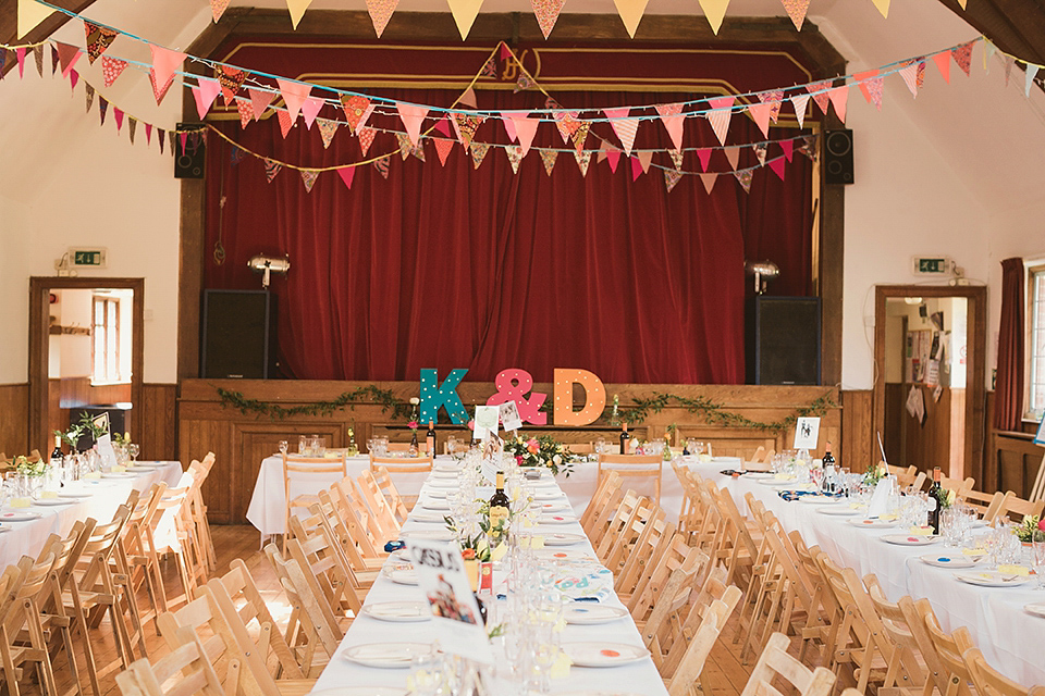 Bride Kate wears a Grace Loves Lace gown for her colourful and Fiesta inspired village hall wedding. Photography by Tom Ravenshear.