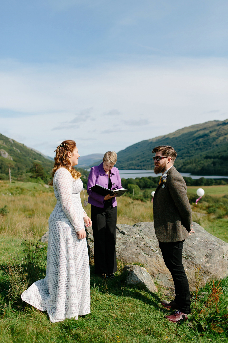 Bride India wears a 1970's inspired gown by Rowanjoy for her Icelandic inspired bohemian and free spirited wedding at Monachyle Mhor in Scotland. Photography by Caro Weiss.