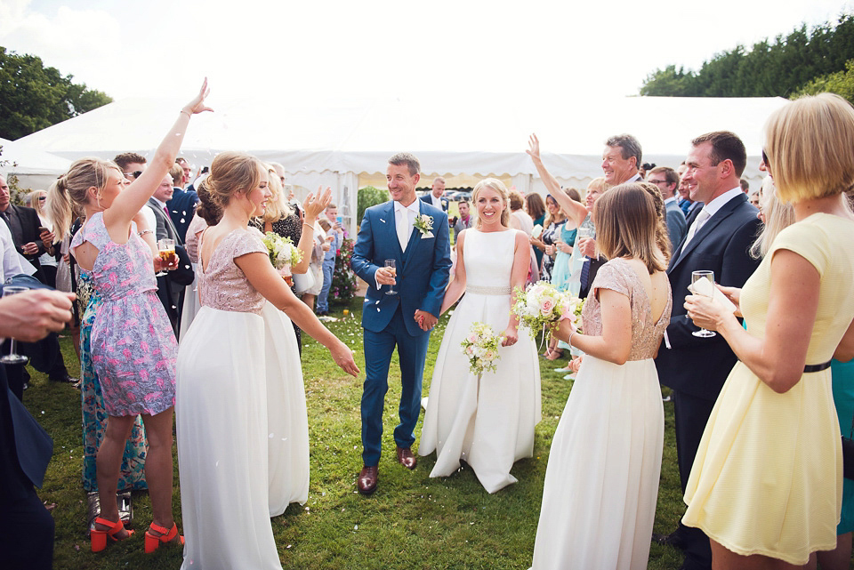 Bride Rosanna wore a Jesus Peiro gown from Miss Bush Bridal in Surrey for her glamorous and romantic English country garden wedding. Photography by Juliet McKee.