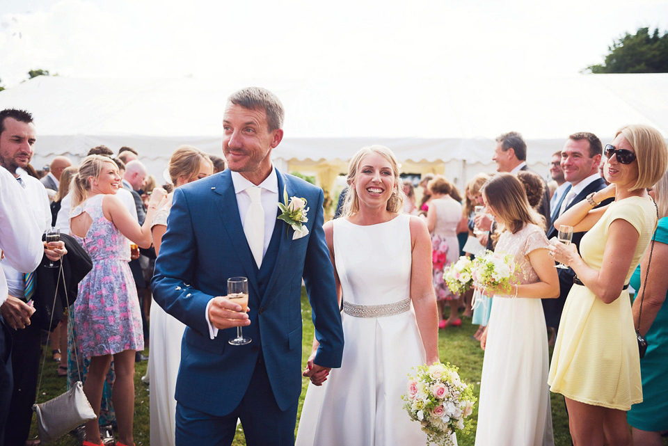 Bride Rosanna wore a Jesus Peiro gown from Miss Bush Bridal in Surrey for her glamorous and romantic English country garden wedding. Photography by Juliet McKee.