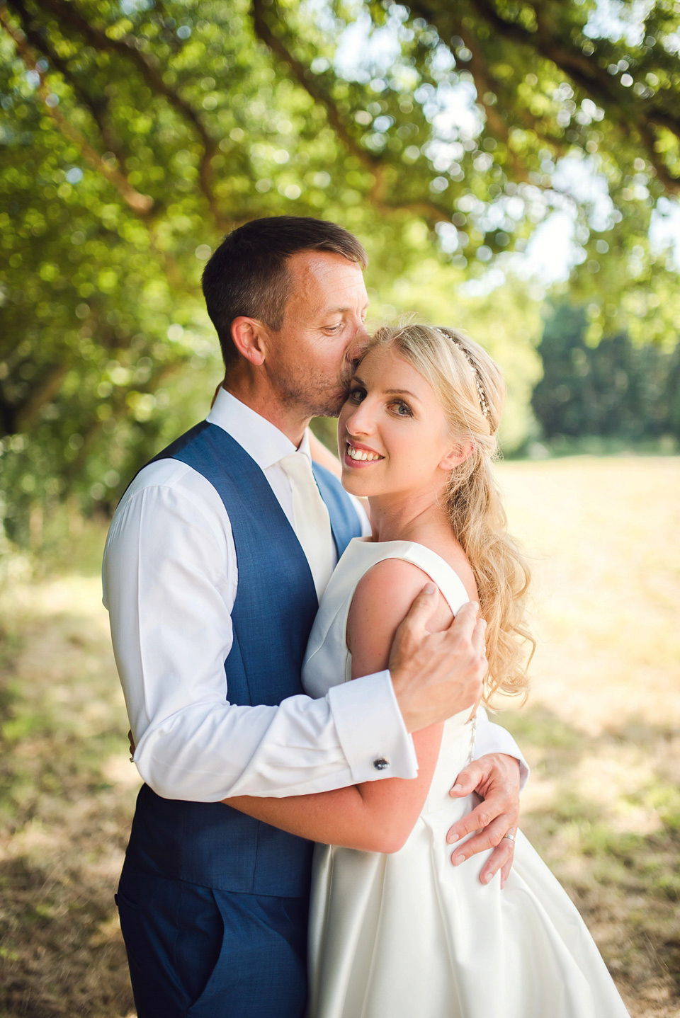 Bride Rosanna wore a Jesus Peiro gown from Miss Bush Bridal in Surrey for her glamorous and romantic English country garden wedding. Photography by Juliet McKee.