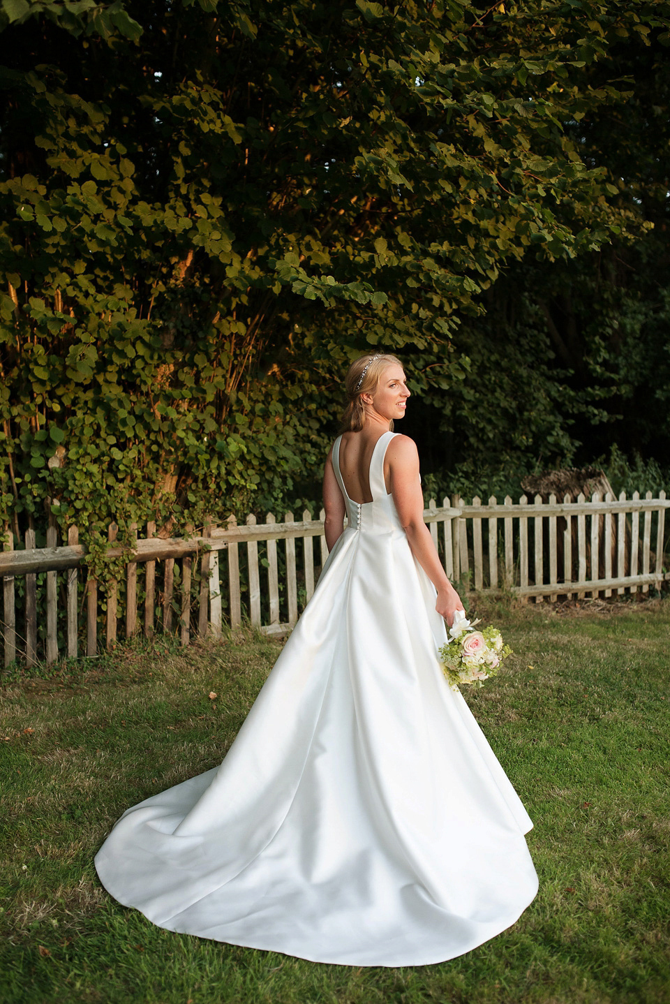 Bride Rosanna wore a Jesus Peiro gown from Miss Bush Bridal in Surrey for her glamorous and romantic English country garden wedding. Photography by Juliet McKee.