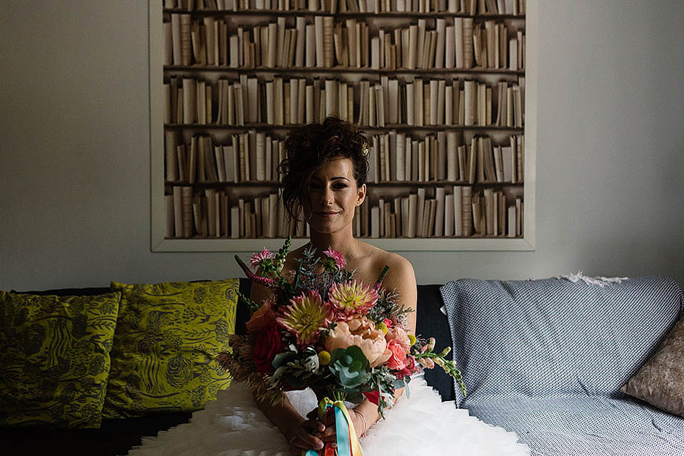 Audrey wore a 1950's inspired tiered wedding dress by Mooshki Bridal for her outdoor wedding in Scotland. The colourful and quirky wedding ceremony was held within the ruins of a chapel. Photography by Paul Joseph.